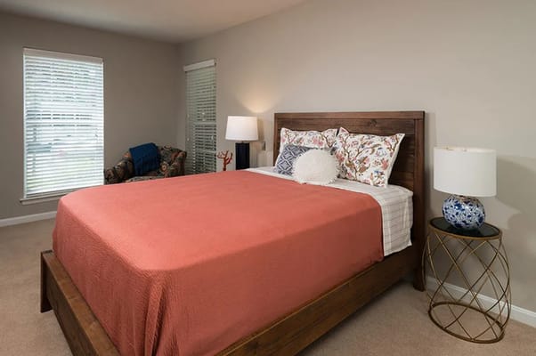 Cozy bedroom with a wooden bed and floral decor