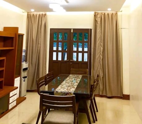 Dining table with brown chairs and double doors