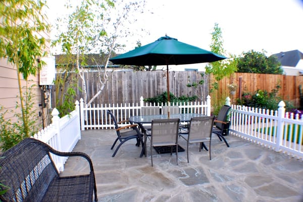 Outdoor seating area with patio and umbrella