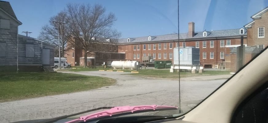 View of Governor Bacon Health Center showing multiple buildings and a green lawn.