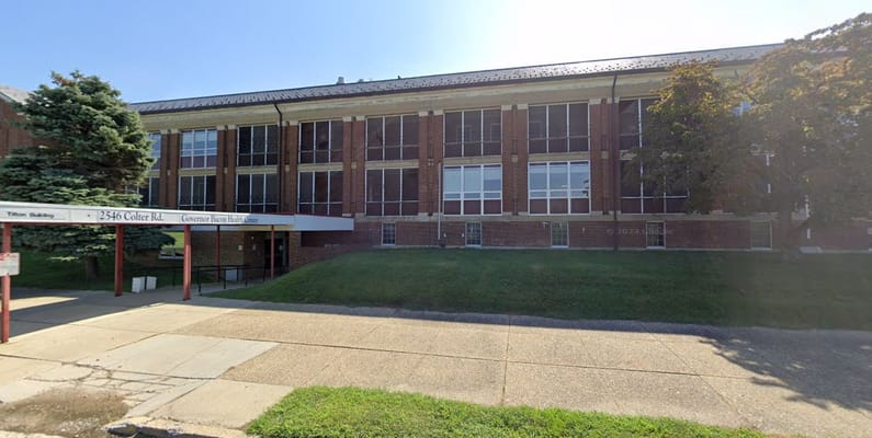 Exterior view of Governor Bacon Health Center showing entrance and surrounding area.
