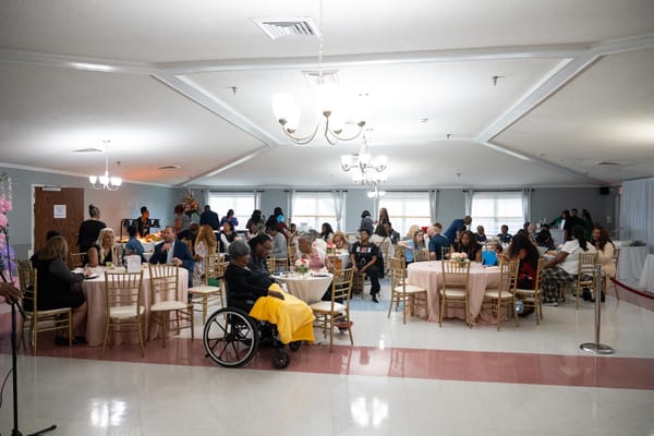 A vibrant gathering in a common area with residents and staff