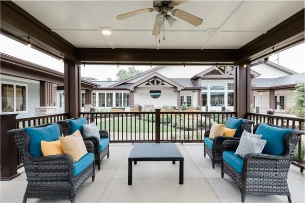 Comfortable outdoor seating area with blue and white cushions overlooking the courtyard