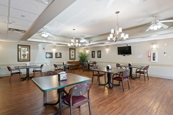 Dining area with tables and chairs in a well-lit interior