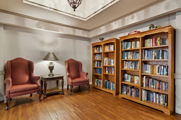 Cozy reading area with bookshelves and armchairs