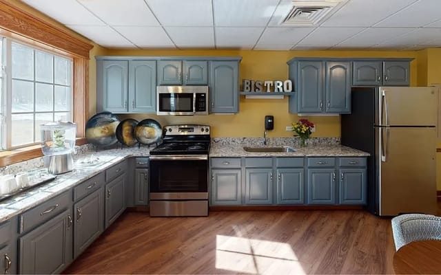 Modern kitchen with gray cabinets and stainless steel appliances