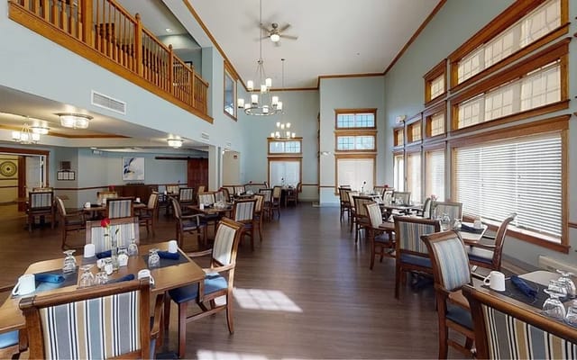 Bright and spacious dining room with tables set for meals