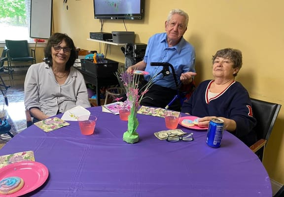 Residents enjoying snacks and conversation at a table