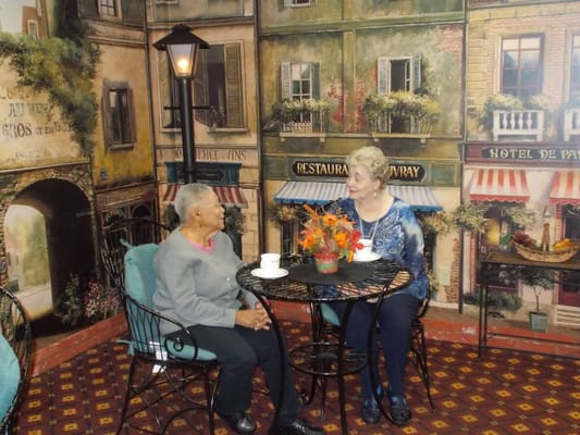 Two residents enjoying coffee in a cozy setting