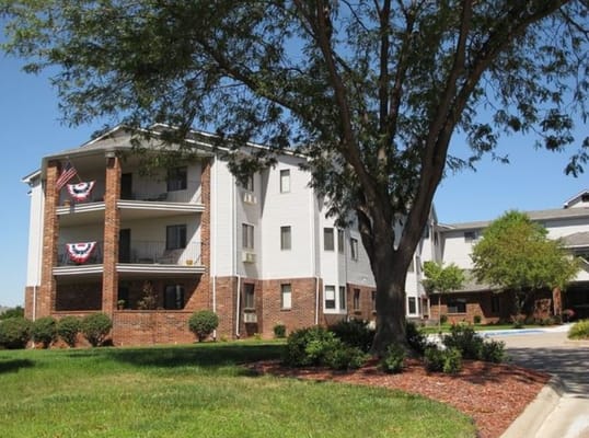 Exterior view of a senior living building with landscaping