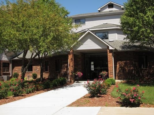 Front entrance of a senior living facility with landscaping