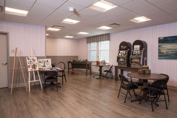 Common area with tables and chairs in a bright room