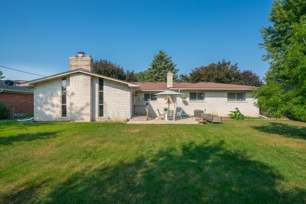 Exterior view of a senior living community building and yard