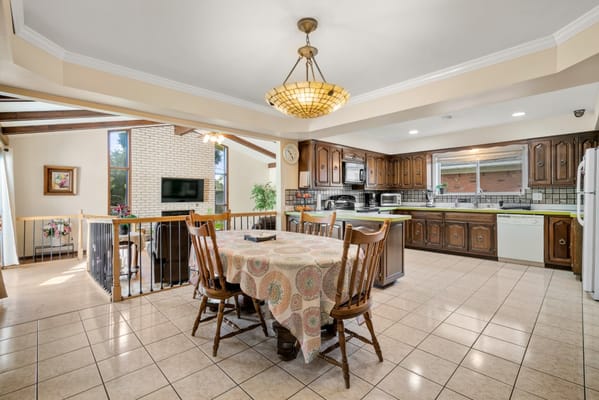 Bright kitchen area with dining table and large windows