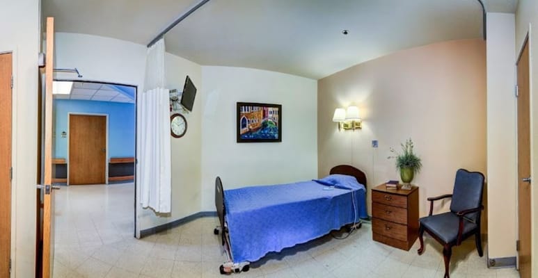 A private resident room with bed and furnishings