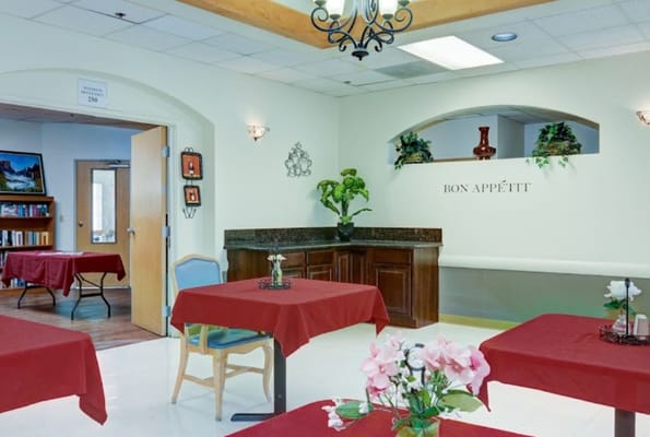 Dining area with red tablecloths and plants