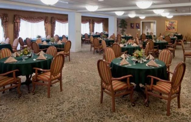 Dining room set for a meal with tables and chairs