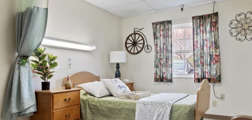 Cozy resident room with floral curtains and decor