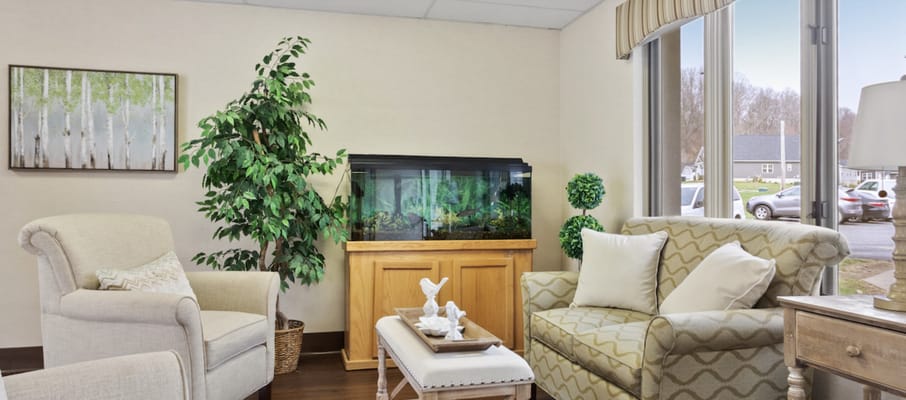 Bright seating area with plants and an aquarium