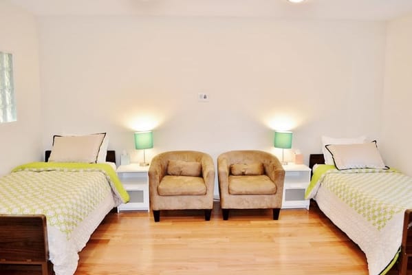 Cozy resident room with two beds and seating
