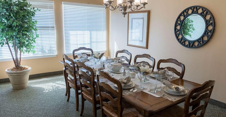 A well-set dining room with a large table and decor