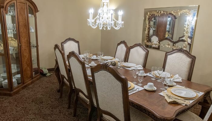 A beautifully set dining table with a chandelier in the Holiday Durham Regent dining room.