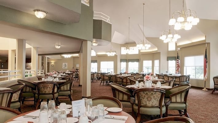 Spacious dining room with tables set for a meal