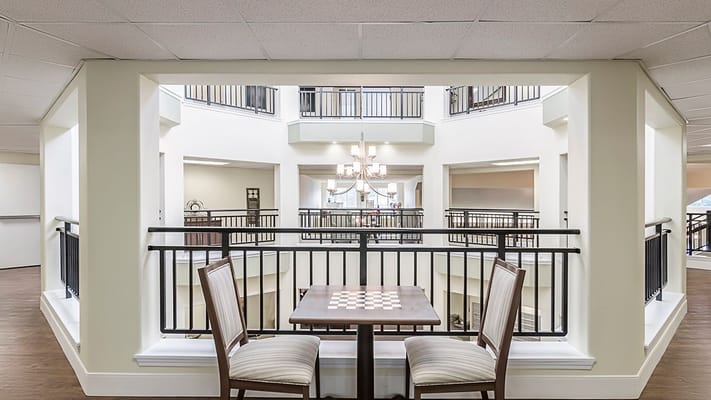 View of common area with seating and chandelier