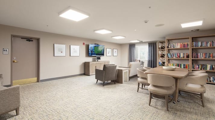 Bright common area with seating and a TV