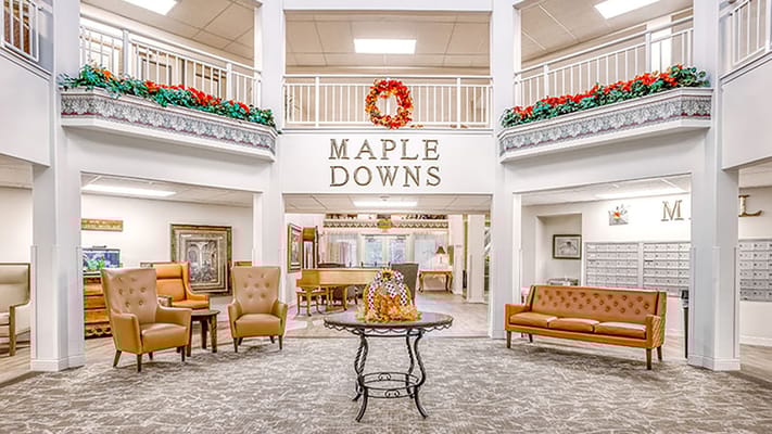 Welcoming lobby at Holiday Maple Downs with seating and decorations.