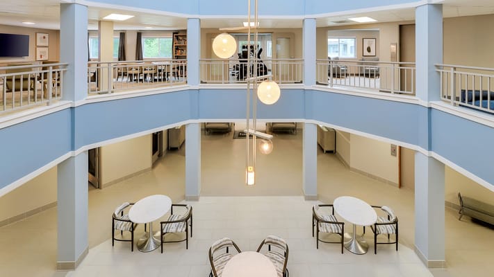 Common area featuring seating and a modern chandelier.
