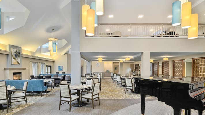 Bright dining area with tables and chairs in Summer Place senior living community