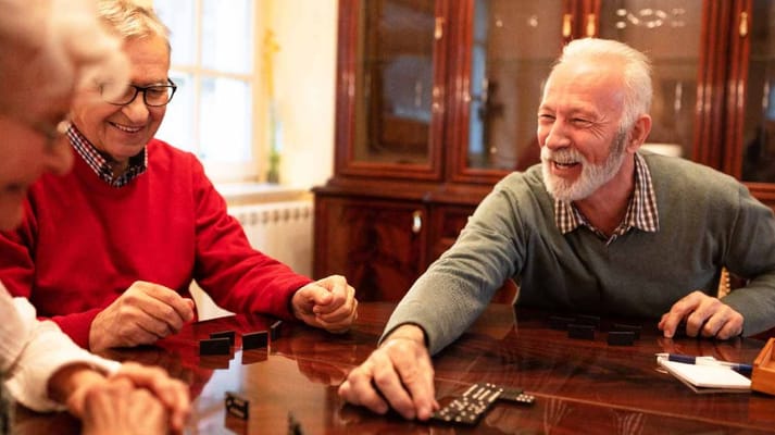 Seniors enjoying a game together at a table