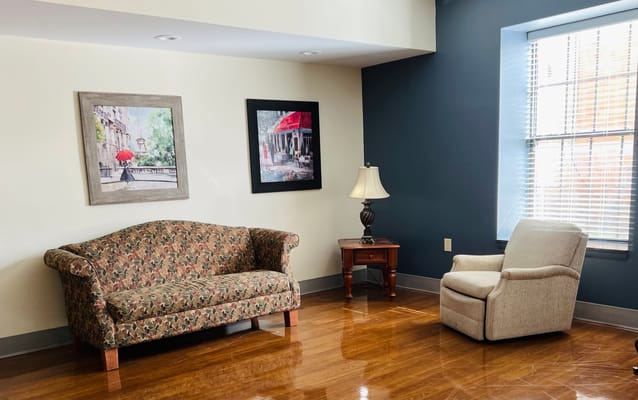 A cozy common area with a sofa and armchair