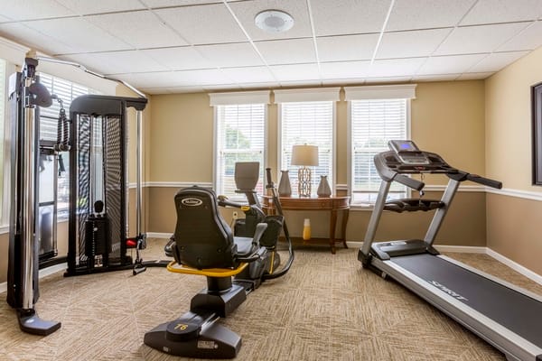 Fitness area with exercise equipment including a treadmill and elliptical machine.