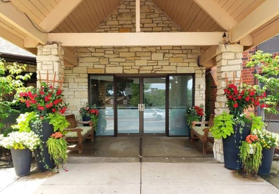 Entrance to a senior living facility adorned with flowers