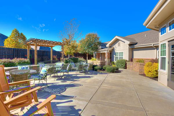 Outdoor patio area with seating and landscaping