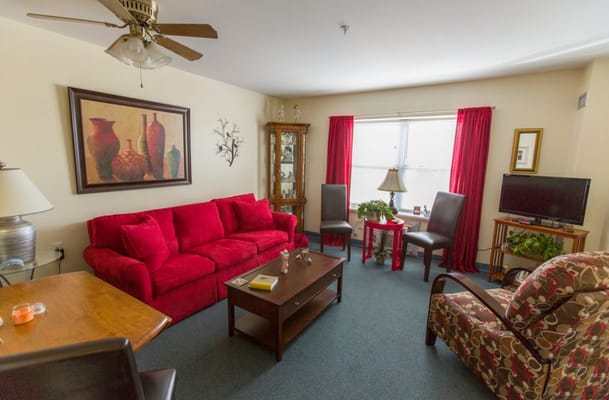 Bright living room featuring a red couch and decorative elements