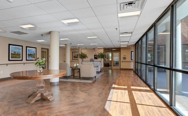 Bright common area with seating and large windows