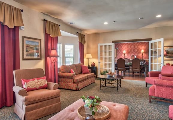 Warm and inviting living room with comfortable seating and floral decor.