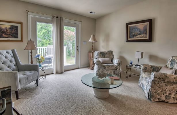 Bright living room with floral furniture and a glass coffee table