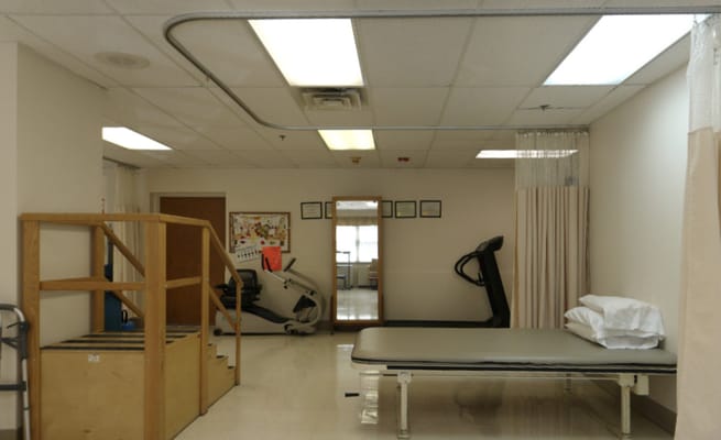 Physical therapy area with equipment and exercise mats