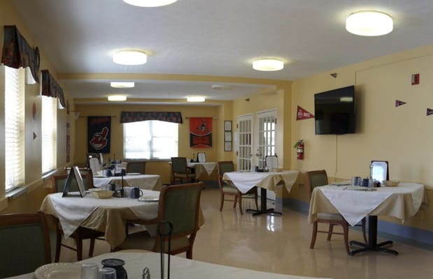 Dining area with tables set for residents