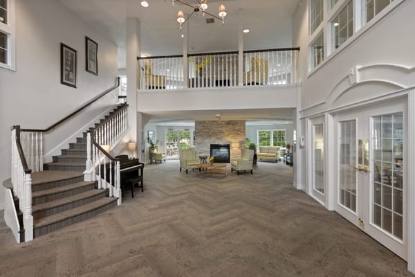 Lobby with staircase and seating area at Legacy Pointe