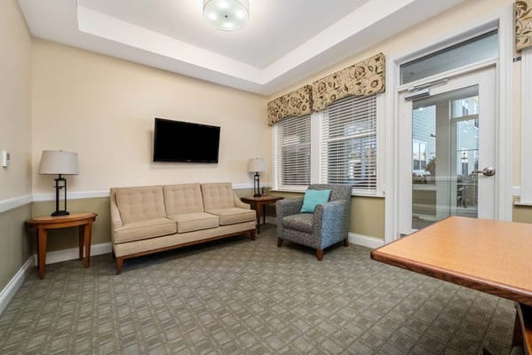 Bright common area with seating and large windows