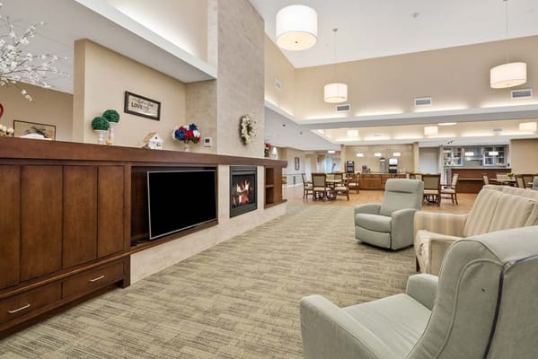 Bright common area with seating and a fireplace