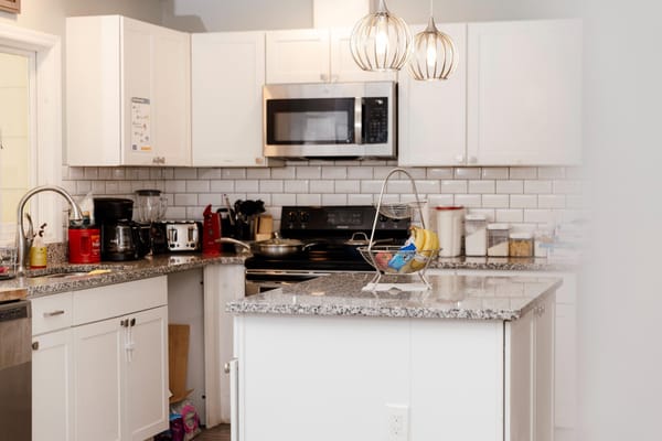Modern kitchen interior with granite countertops and appliances