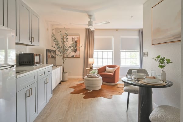 Bright and modern apartment interior featuring a seating area and dining table.