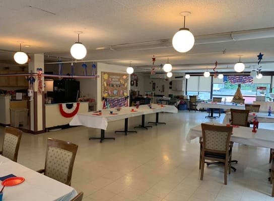 Interior view of a decorated common area with tables