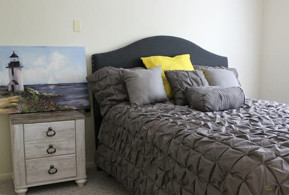 Cozy bedroom with a decorative painting and bed linens